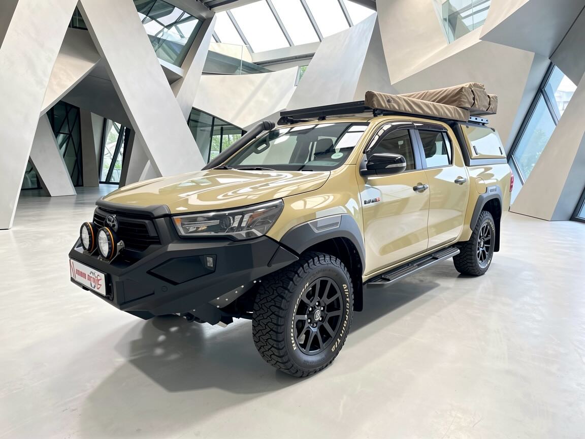 Toyota Hilux pickup truck placed in modern architectural building with geometric skylights
