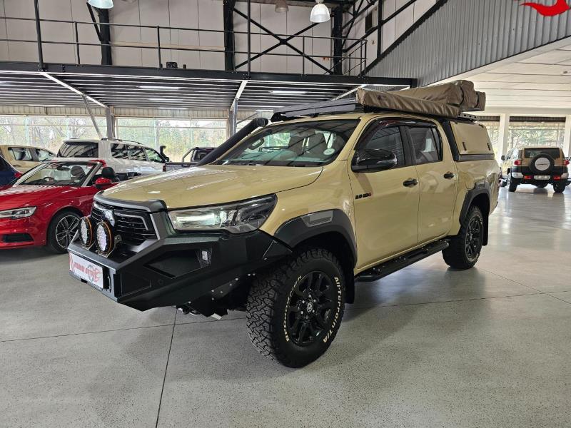 Toyota Hilux pickup truck in warehouse showroom before custom scene enhancement